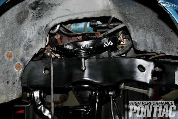 17. After installing the provided heavy-duty ball joint on the upper control arm, the front-end was thoroughly cleaned. The lower control arm was removed to be cleaned, and, along with the frame, was sprayed with a rust-converting black spray paint. New bushings were pressed into the lower control arms and new Moog ball joints and a bump stop round out the lower control arm restoration. After installing the lower control arm, the Gen II upper control arm is placed in position and both arms are torqued per the specifications. We did not install the upper-control-arm alignment shims. Instead we opted to let the front-end-alignment shop handle that task.