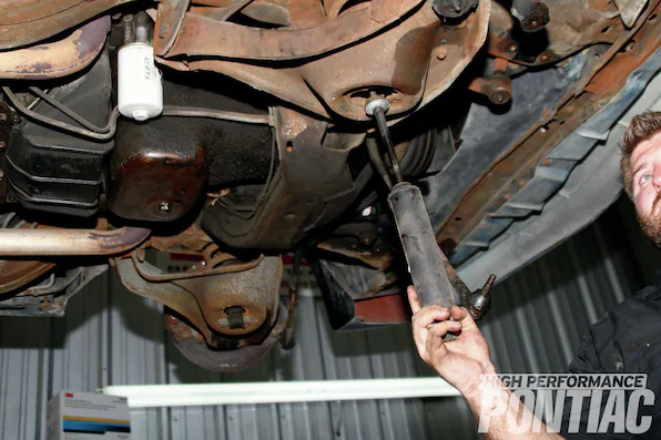 10. The two bolts that hold the shock in the lower mounts are easily removed with a 9&frasl;16-inch socket. Once the bolts are out, we pulled the shock out the bottom. In this case, the shocks were Monroe Sensa-Tracs, a common replacement shock that is nitrogen filled and calibrated for extra control and comfort. Although the shocks were not leaking, the fronts could be compressed by hand. That&rsquo;s always a first indicator that replacement is needed.