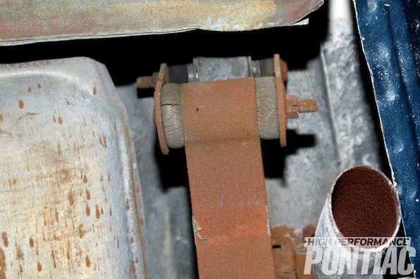 24. Moving to the rear, the wheels were removed and the rear leaf spring was inspected for damaged leafs. The rear leaf springs&rsquo; bushings on both ends are original and the rubber is cracked; leading to rear deflection on cornering and the tendency for axle wrap, which causes wheelhop on acceleration or deceleration.