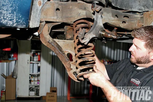 14. Mike inspects the spring and doesn’t find defects but understands now that the driver-side spring will require not only the removal of the steering shaft but the arduous job of loosening the lower control arms. Recently, PTFB came out with competition/race Daytona lower control arms that feature a rectangular-box design and can be fitted with either polyurethane or Delrin bushings (PN 2CS-130, retail $549).