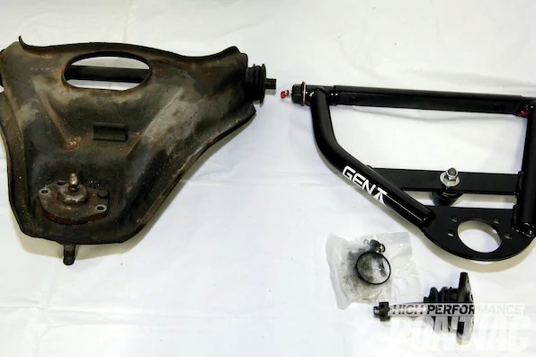 16. A comparison of the stock upper control arm on the left and Gen II Racing control arm on the right demonstrates the big differences between the two. Rather than a stamped piece, the Gen II units have interlocked welded tubes, billet offset cross shafts, solid pivot bushings (greaseable), and are both stronger and lighter. The revised ball-joint angle provides more wheel clearance, and the ability to add positive caster and increase the negative camber curve will allow a more sport oriented front-end alignment.